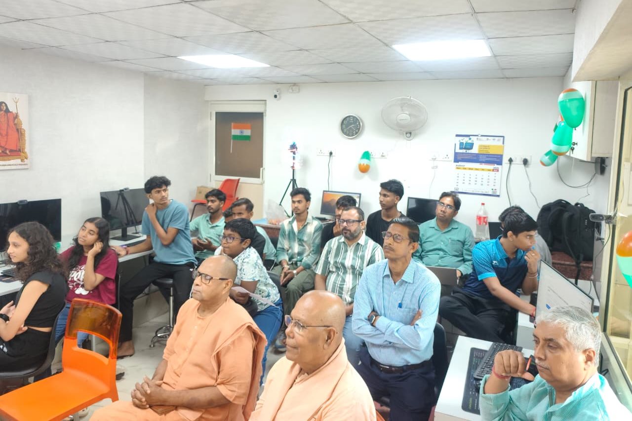 A wider view of the lab during the launch, workstations along both walls and the room full.