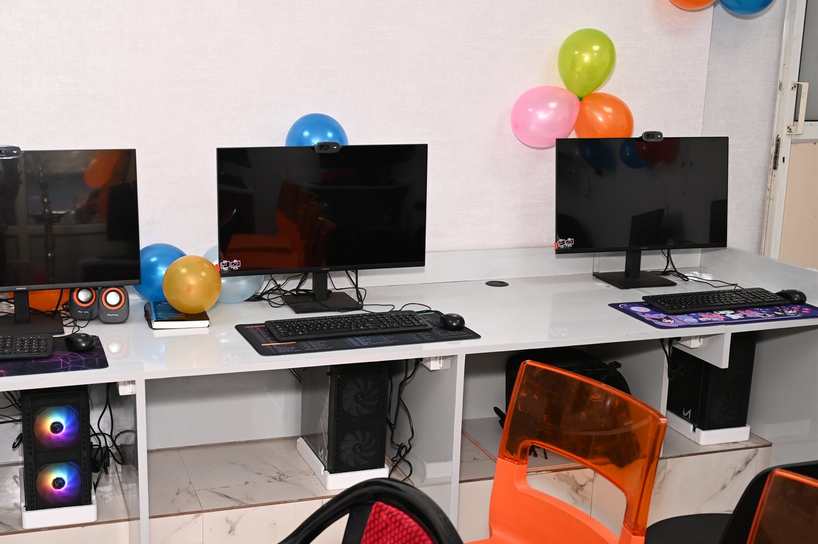 Three of the lab workstations, each with a monitor, keyboard and desktop computer.